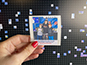 An individual mosaic photo highlighted in front of the building Live Print Mosaic.