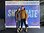 Guests posing in front of the completed Live Print Mosaic.