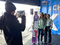 Event staff assisting guests in capturing their photos for the Live Print Mosaic.