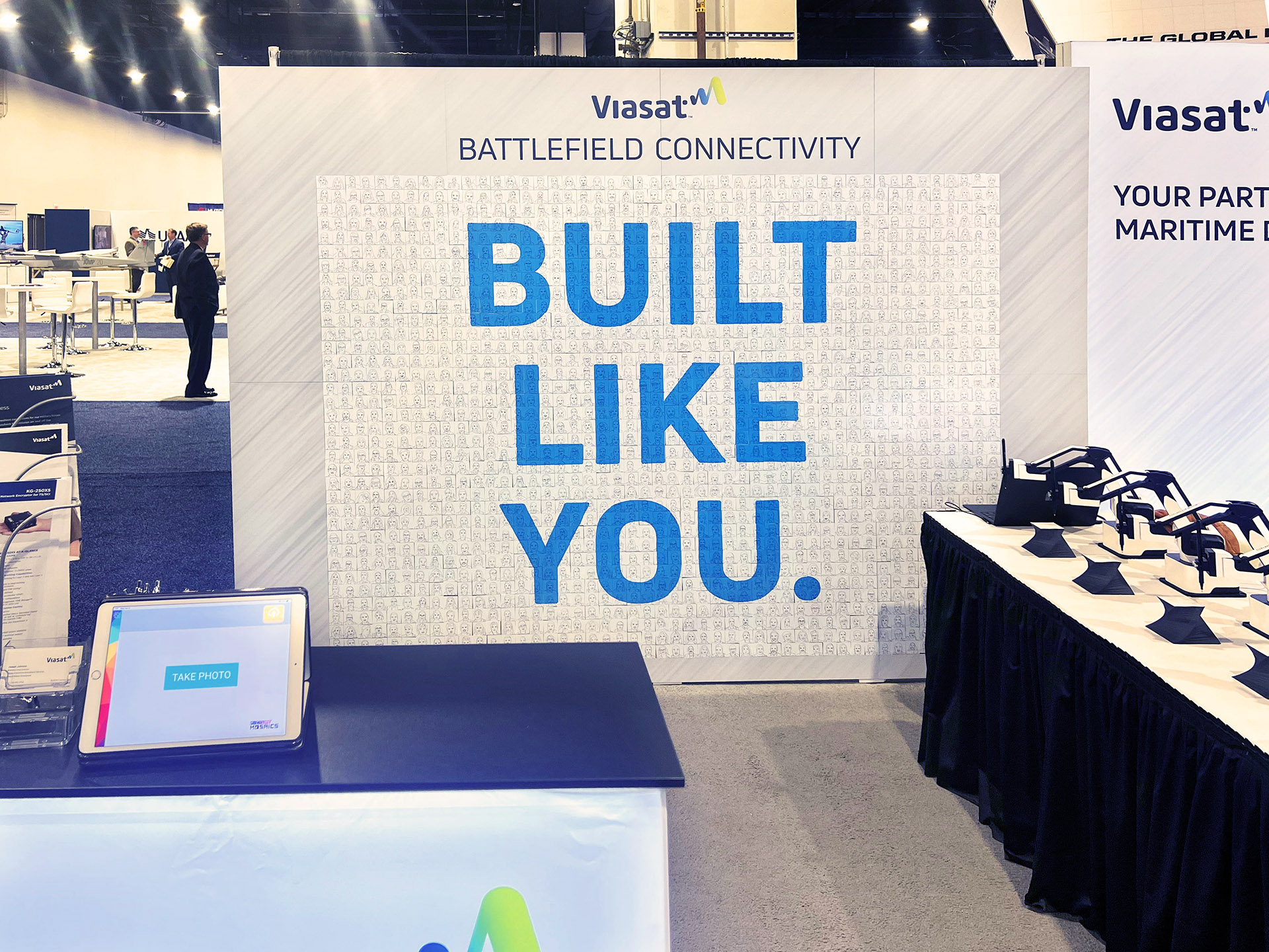 A completed SketchBot mosaic at the Viasat booth, showcasing a large mosaic artwork.