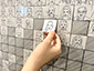 Guests actively participating by placing their sketches on the SketchBot mosaic wall.