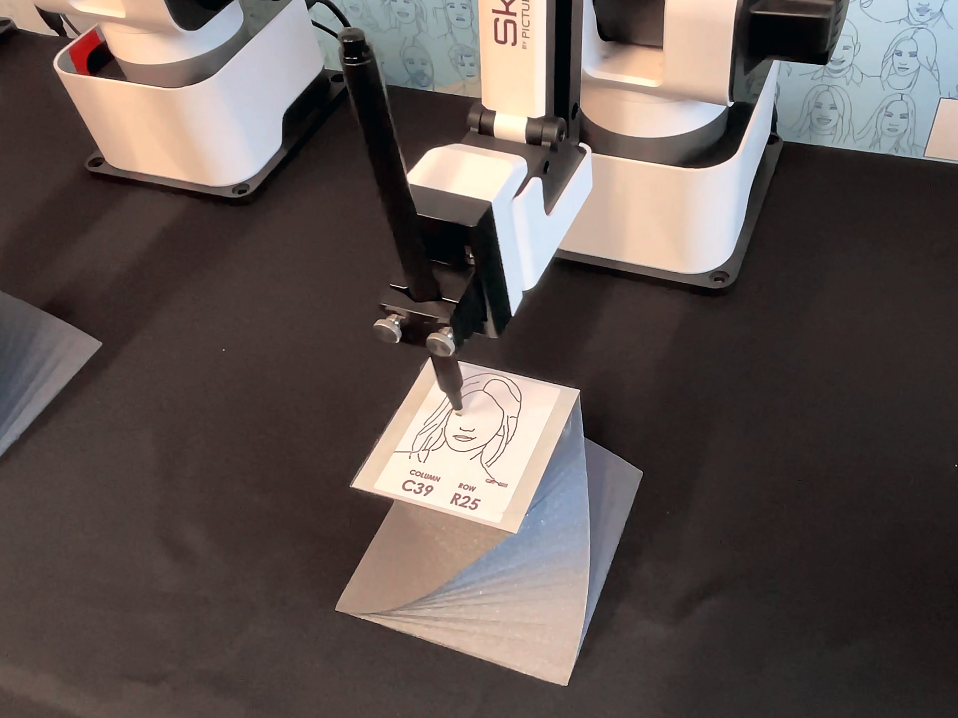 A close-up shot of the SketchBot sketching a guest’s portrait.