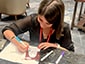 Guest coloring her personalized SketchBot portrait at activation station