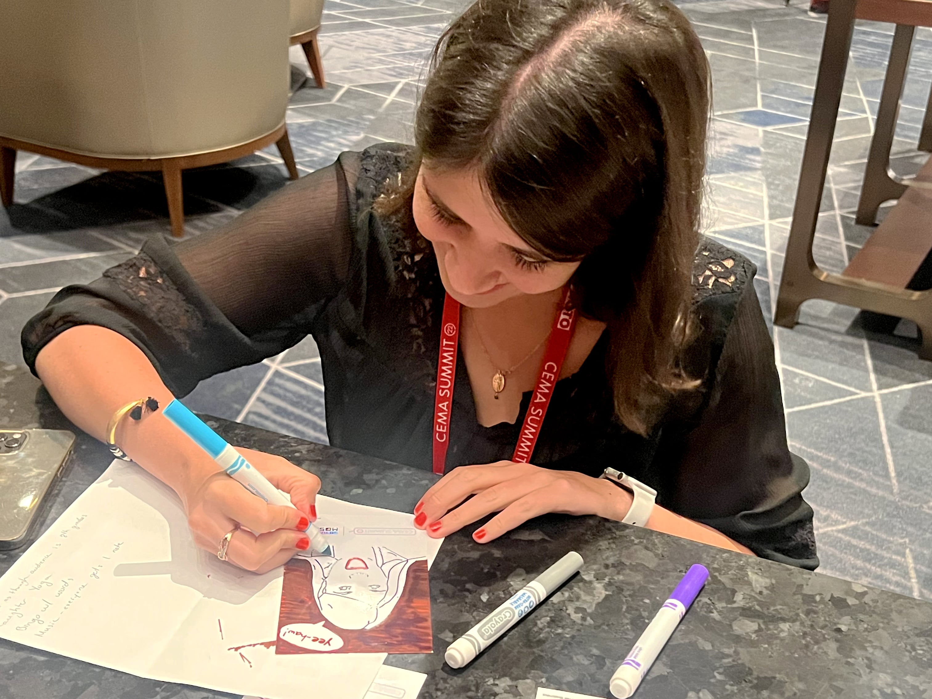 Guest coloring her personalized SketchBot portrait at interactive station