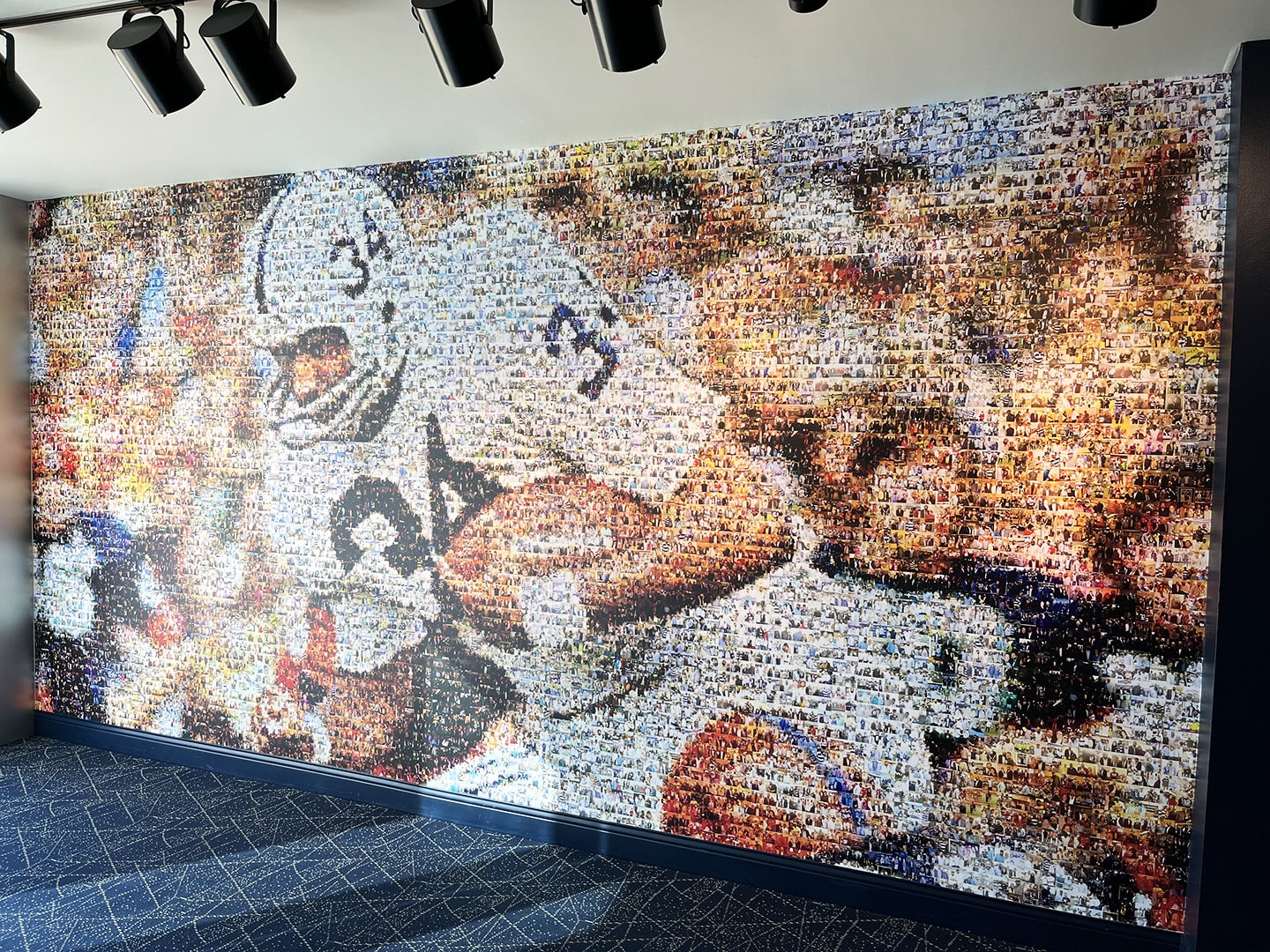 Memorial mosaic mural of Franco Harris running and holding a football