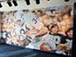 Memorial photo mosaic mural of Franco Harris in action holding football
