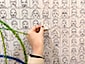 Close-up of live sketch mosaic wall as participant places their portrait tile