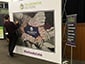 Guest placing their photo tile onto the interactive mosaic wall