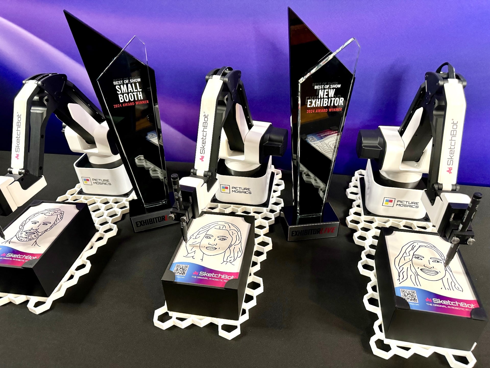 Ai SketchBots with two awards they won at ExhibitorLive 2024