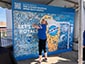 Smiling guest placing their photo onto the photo mosaic wall