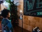 Person posing for a photo at a selfie kiosk, ready for SketchBot to draw their portrait