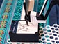 Close-up of a SketchBot drawing a guest's portrait on custom branded paper