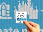 Close-up of an adhesive sketch portrait tile, with a SketchBot Mosaic in the background