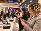Guests recording with their phones as drawing robots sketch their portraits