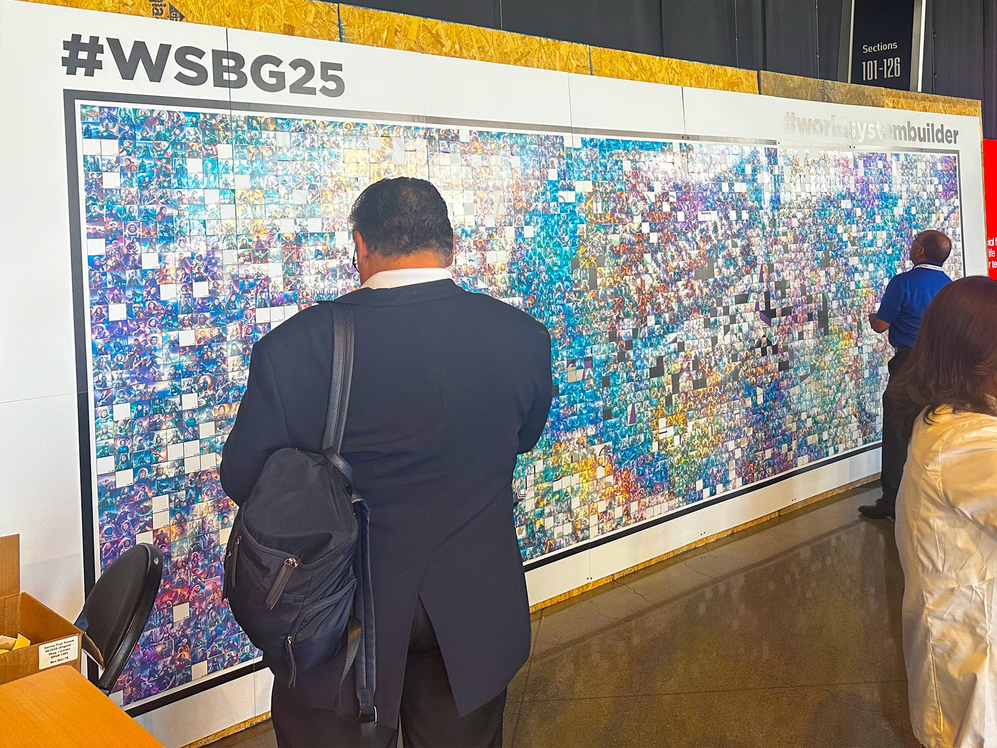 An almost completed Ai Mosaic with guest looking and adding to it