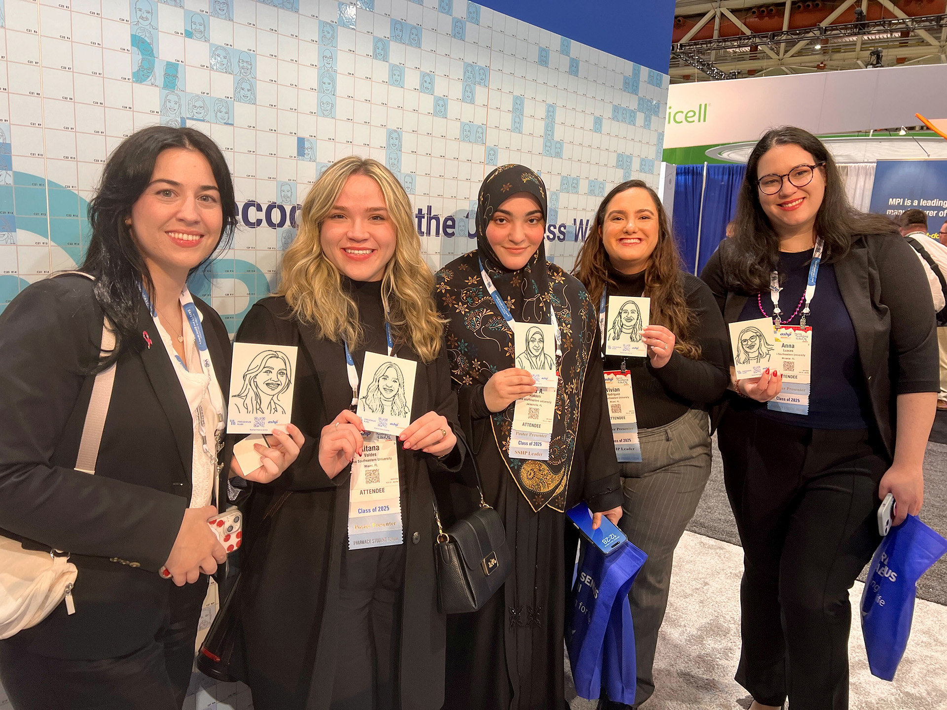 Guests holding up their SketchBot caricatures