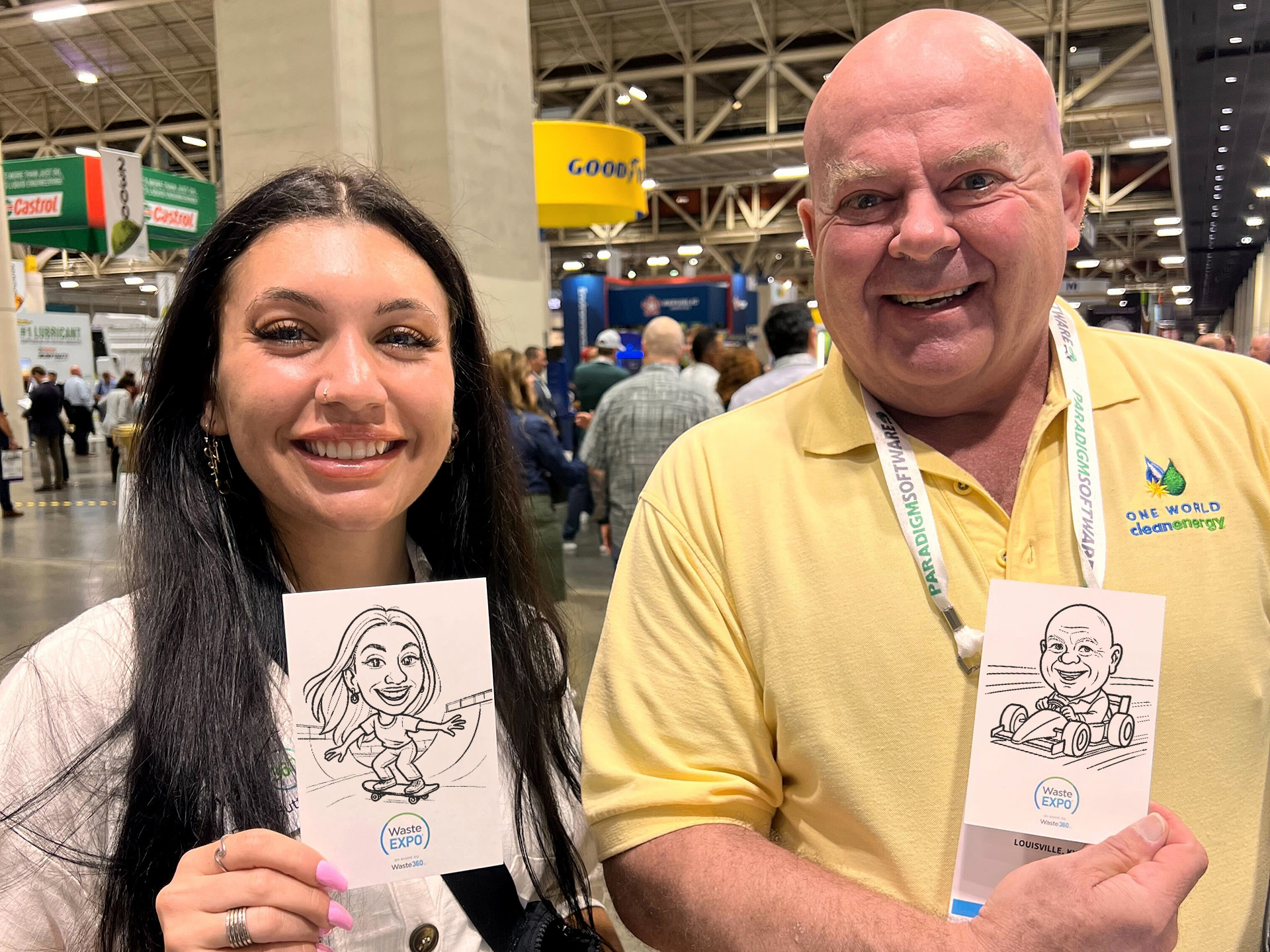 Two attendees displaying their robotically drawn portraits from SketchBot activation