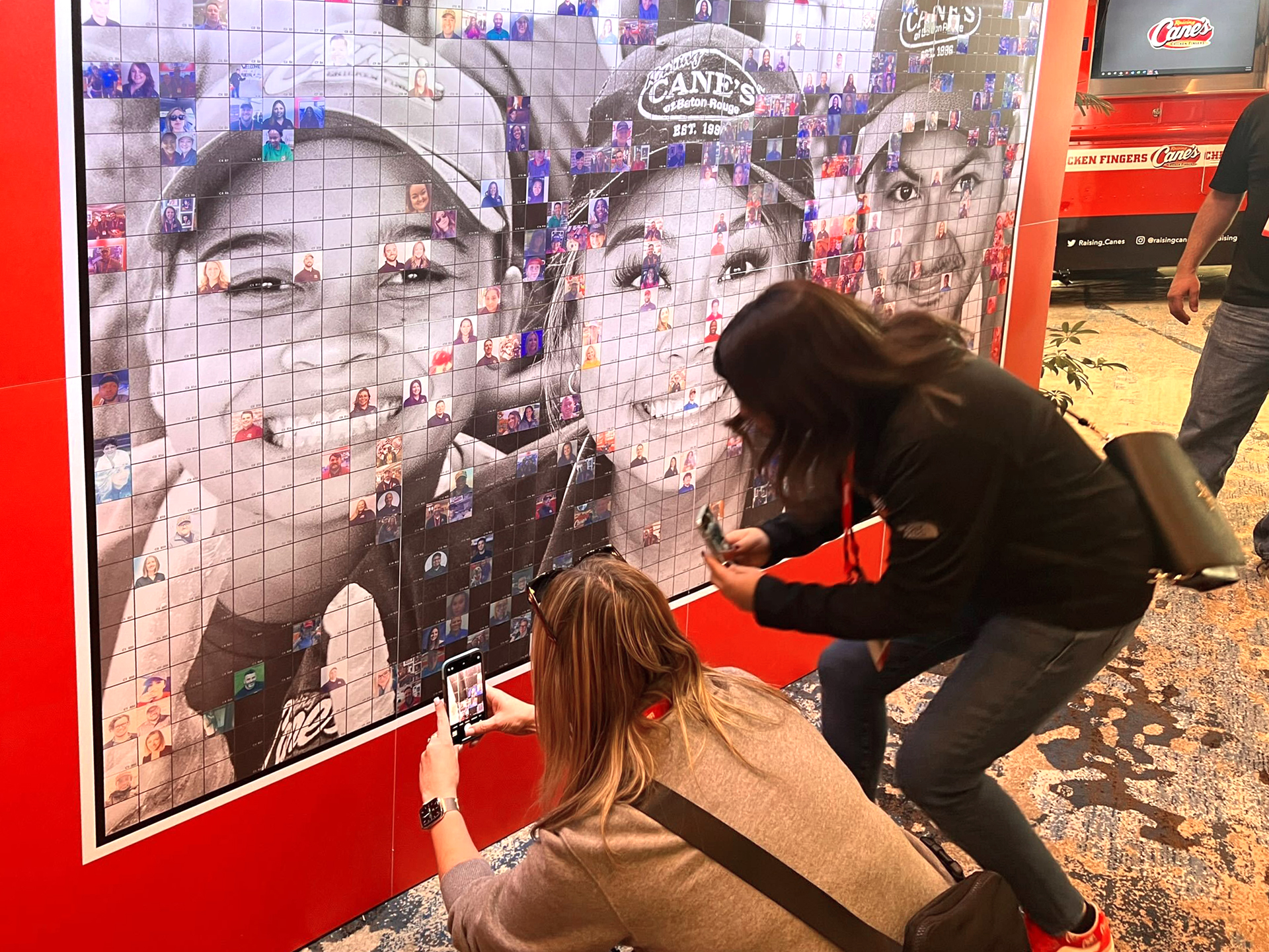 Employees placing their image on the photo mosaic