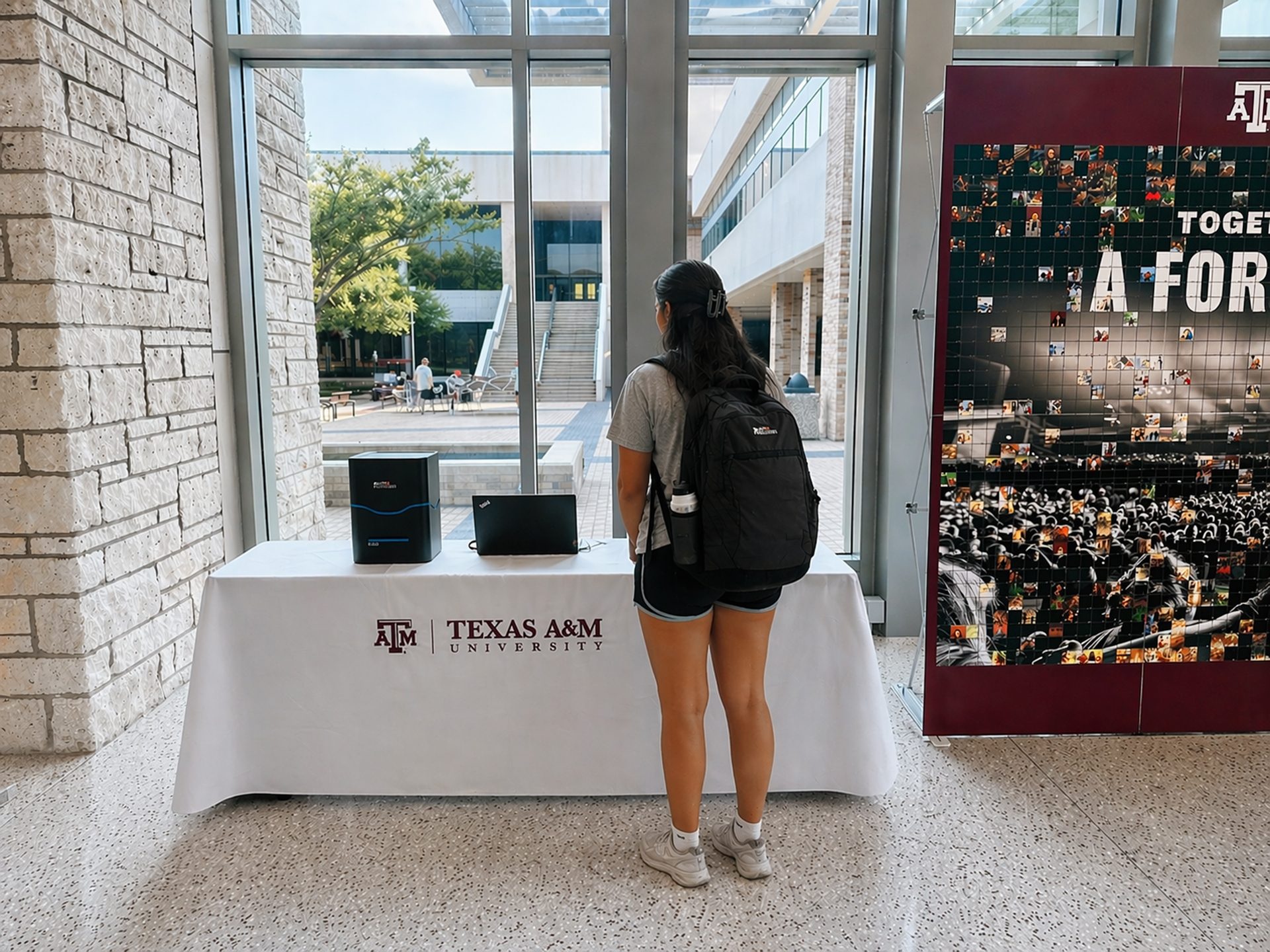 A student waiting to take their sticker from the printer