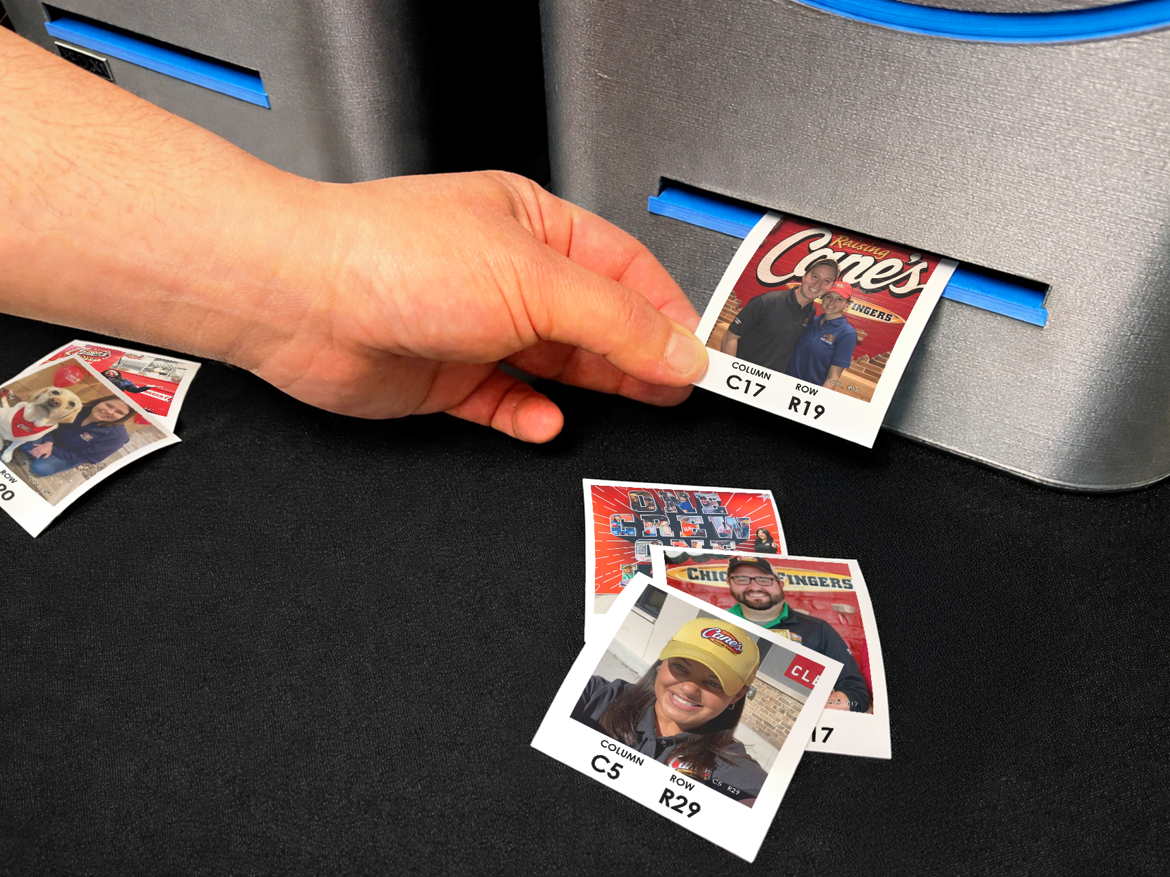 A participant taking their photo from the printer