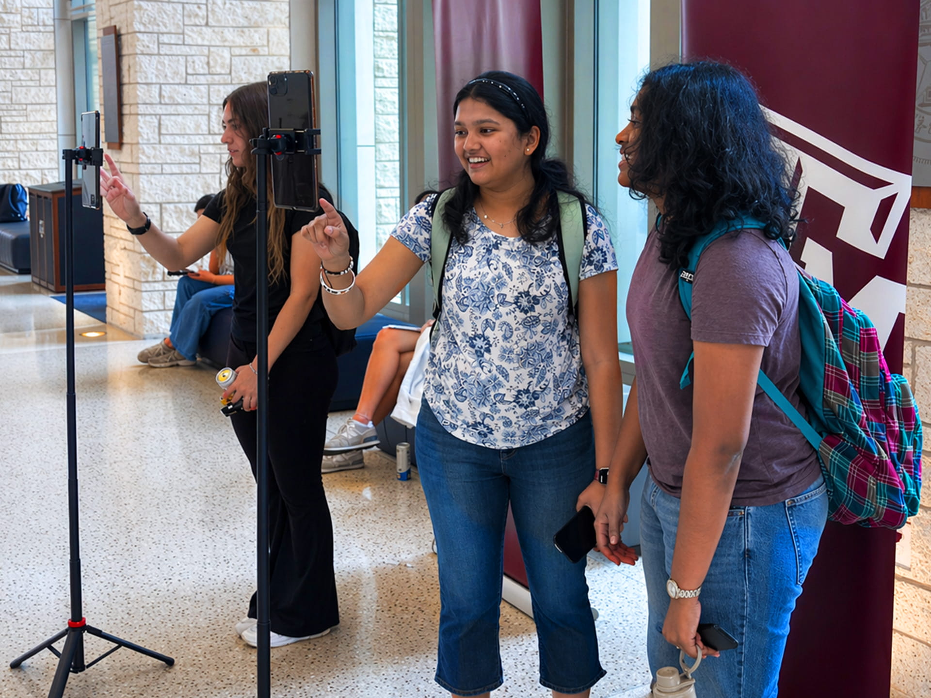 Students taking their photo to place on the photo mosaic wall