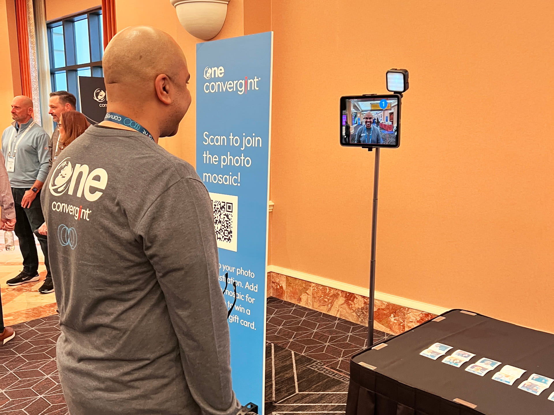 A man taking his photo for the photo mosaic wall