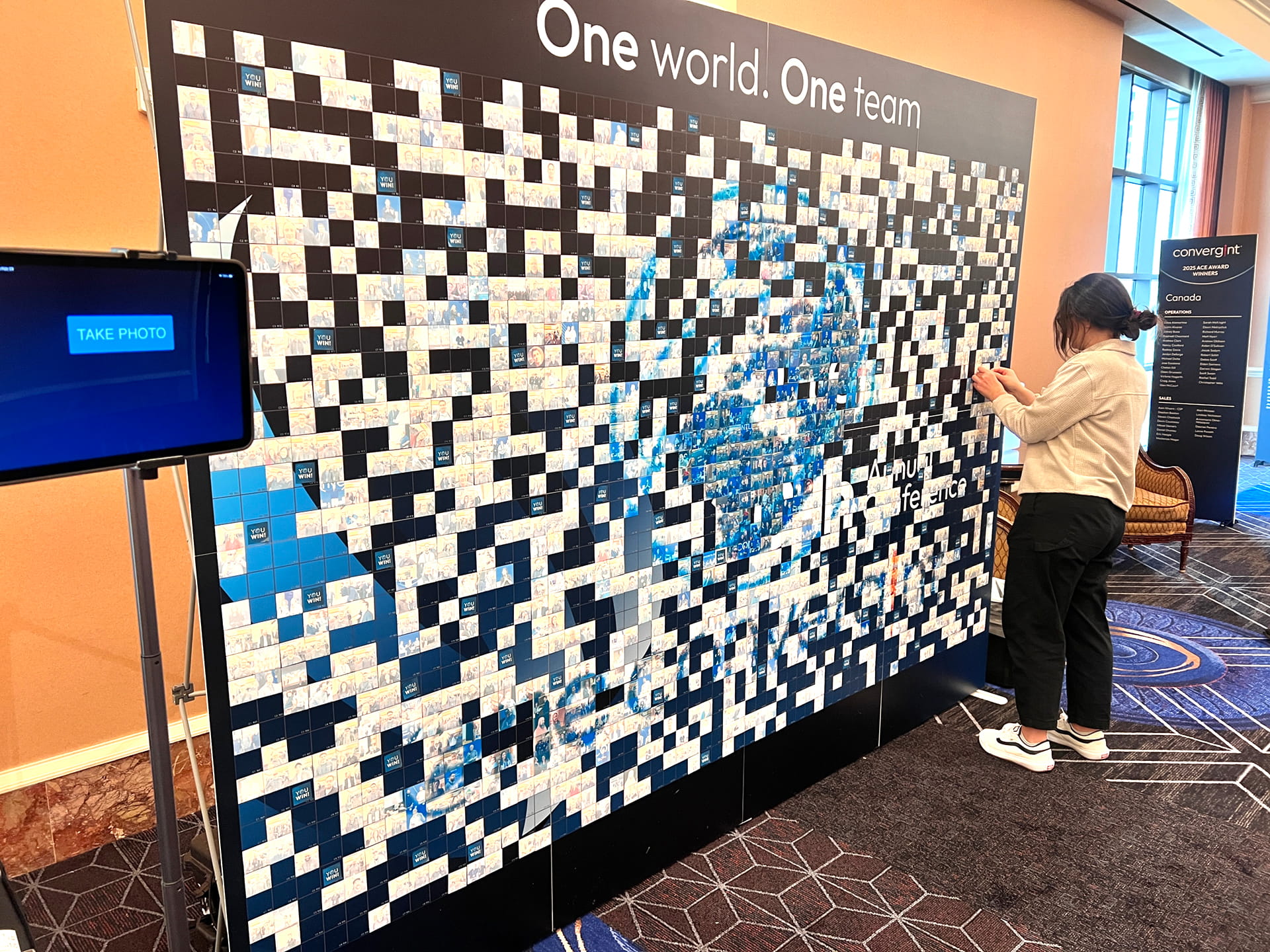 Participants placing their photos on the mosaic wall