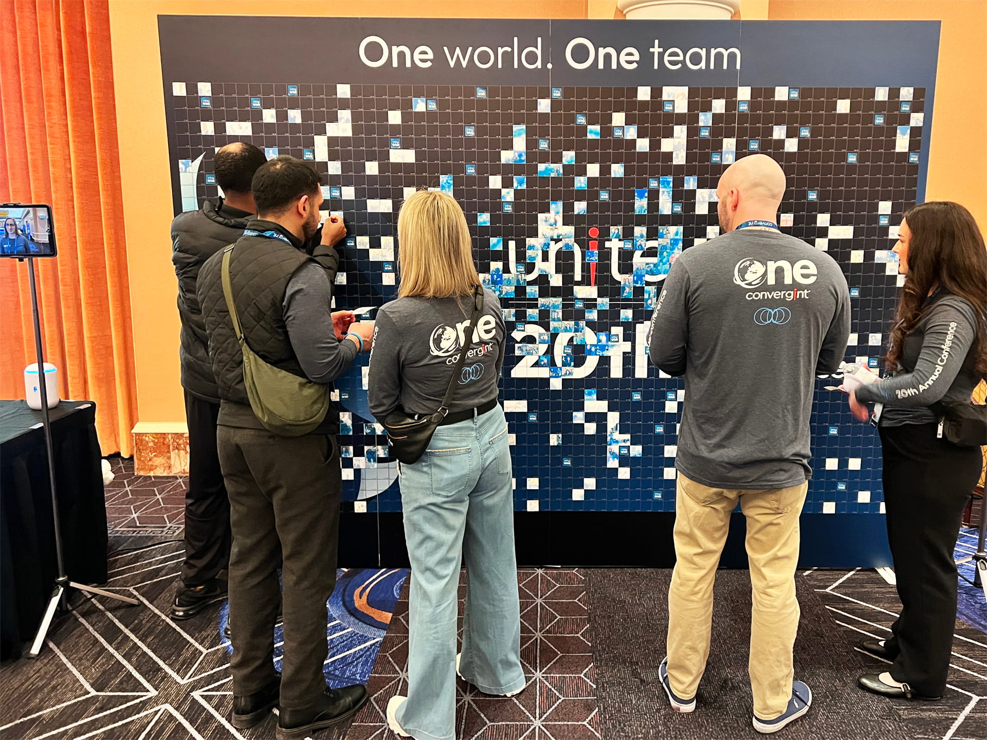 Guests placing their photos onto the photo mosaic wall