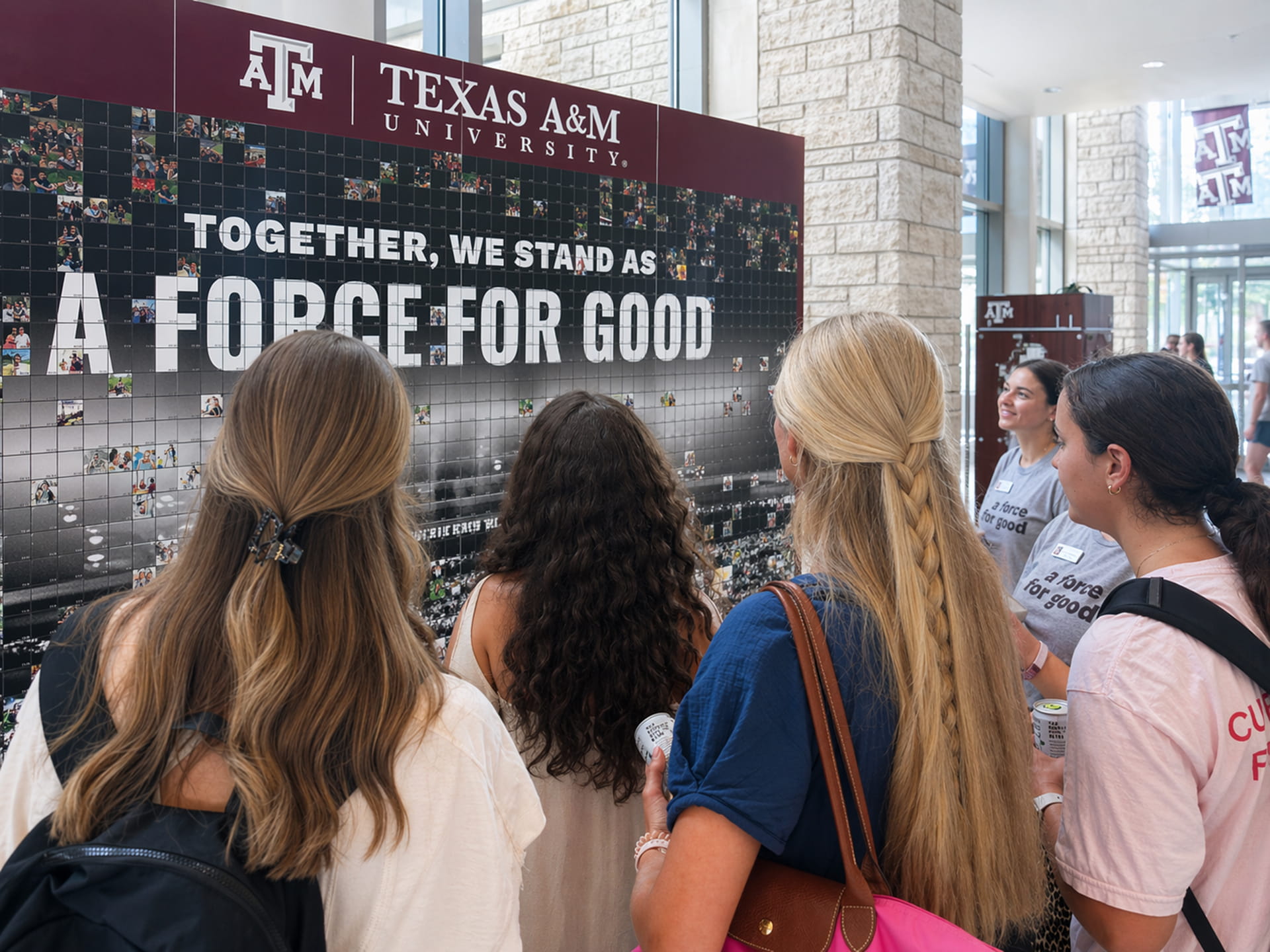 Participants placing their photo on the photo mosaic wall