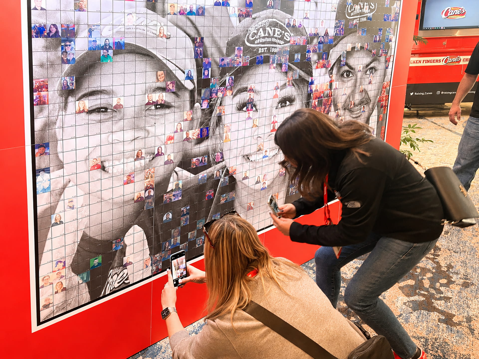 Employees placing their image on the photo mosaic