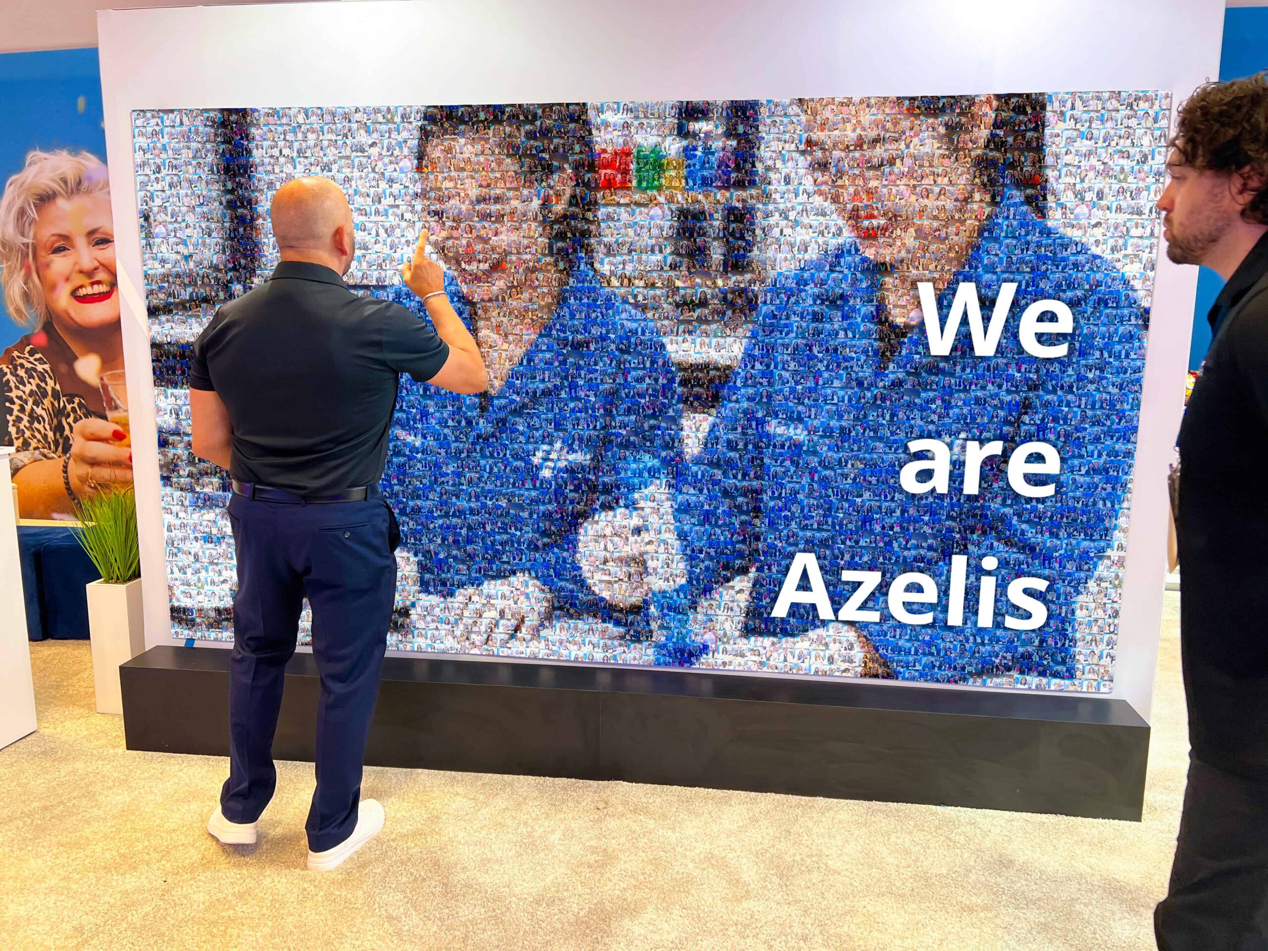 A man looking at his photo in the completed photo mosaic
