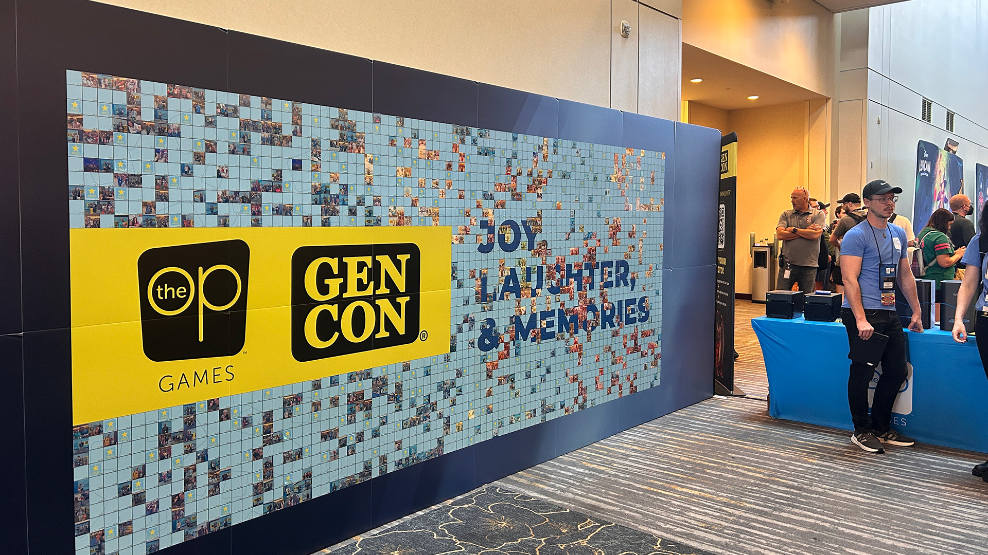 The set up of the photo mosaic wall at USAOPOLY's booth