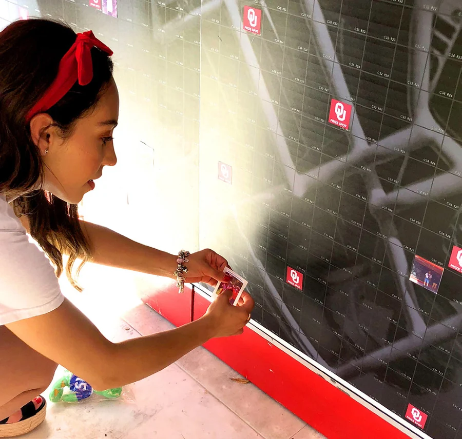Guest placing a printed cell onto a live mosaic wall.