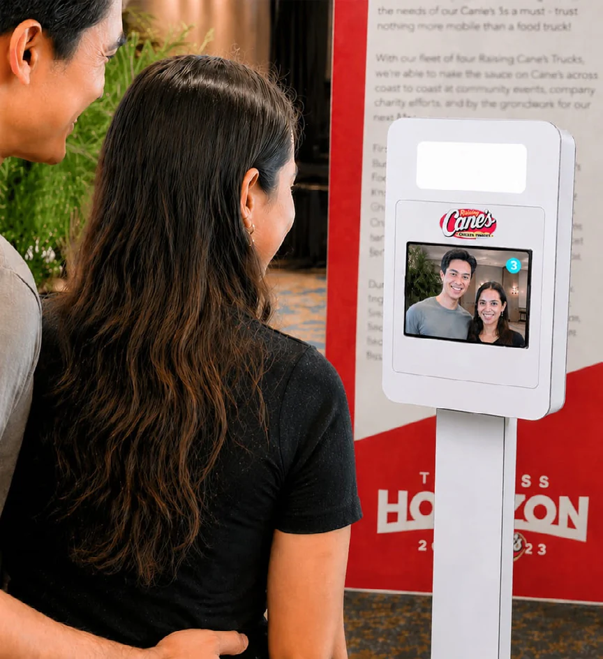 Guest using a branded photo booth kiosk.