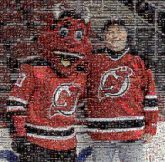 New Jersey Devils Team sport Mascot Sports uniform Sportswear Sleeve Red Cap Headgear Ice hockey equipment Sports jersey