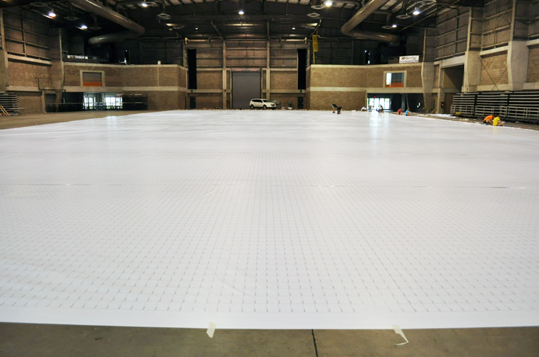 Over 21,000 square feet of vinyl is laid out and gridded in preperation for the mosaic.